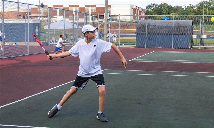 A tennis player hits the ball